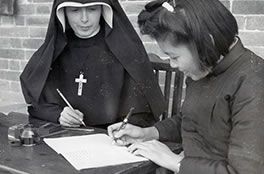 Columban Sister and girl studying