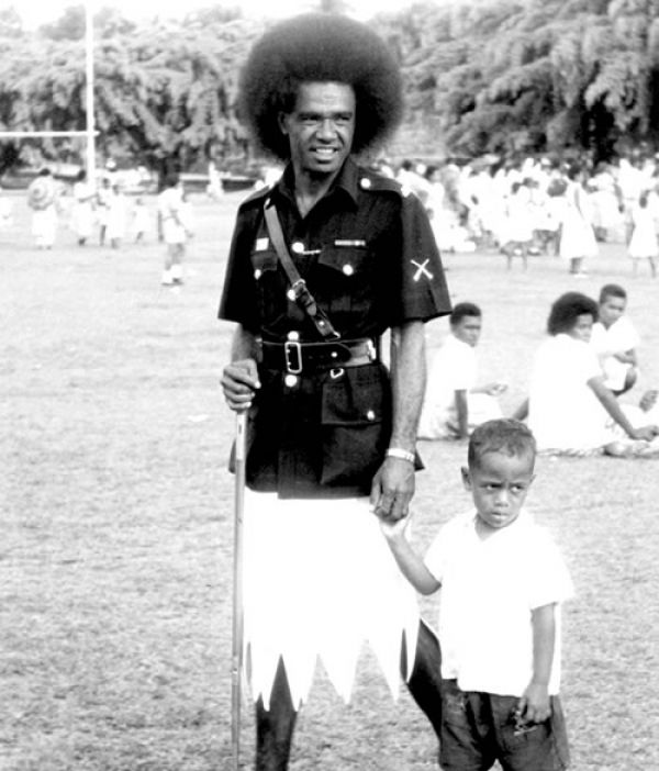 Fijian policeman with a young boy