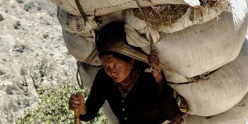 Woman carrying a heavy load